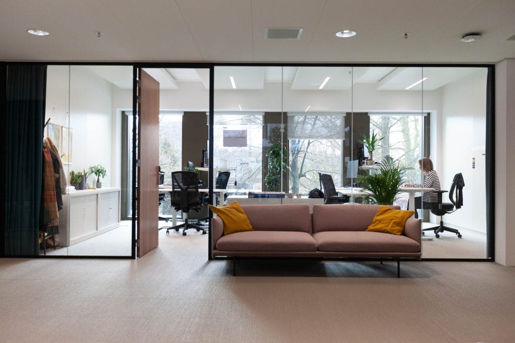 Gemütliches Büro mit recycelten Möbeln und einem biophilen Design mit Pflanzen, natürlichen Farben und Materialien