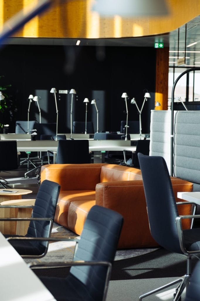 Personalized office workspace with adjustable desks and ergonomic seating for optimal comfort.