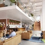 Eine geräumige, moderne Lobby mit einem Zwischengeschoss. Menschen entspannen und unterhalten sich auf Sofas und in einem speziellen Arbeitsbereich. Große Fenster, Zimmerpflanzen und stilvolle Kugelleuchten verstärken die offene, luftige Atmosphäre. Ein Bild von EDGE Workspaces.