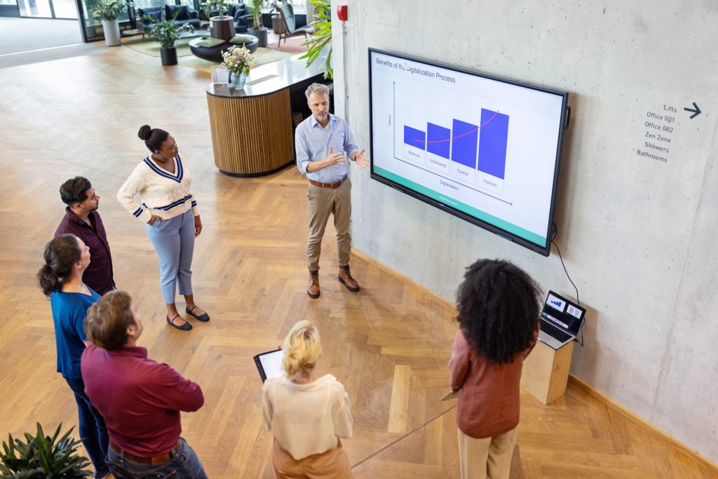 Team discussing AI-driven data insights for predictive maintenance in modern office spaces at EDGE Workspaces.